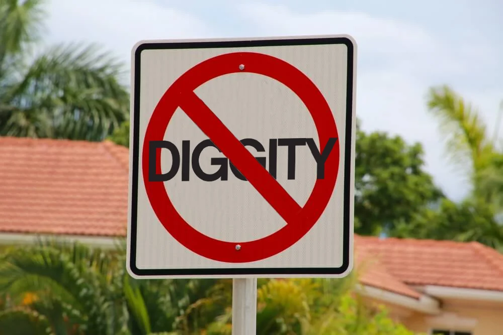 Street sign with red circle and slash over the word DIGGITY